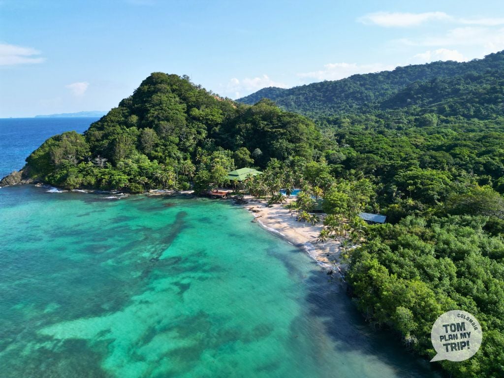 Aerial view of the remote, low-density bay and rainforest